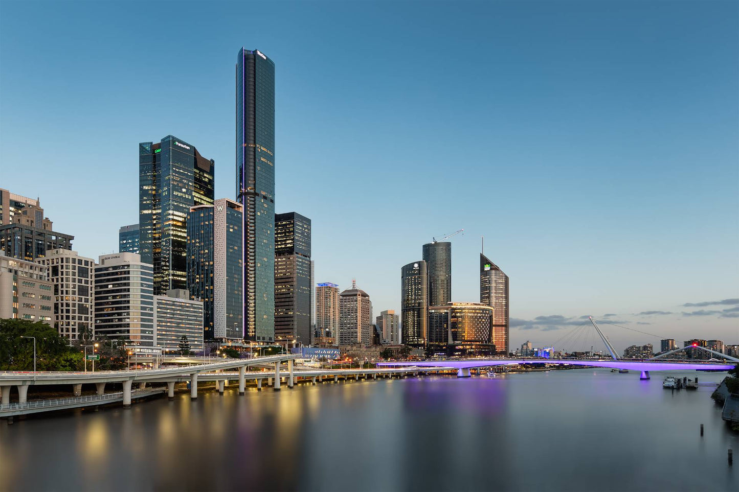 Brisbane city skyline at blue hour with illuminated skyscrapers, reflections on Brisbane River, and iconic bridges — Brisbane CBD photography print.