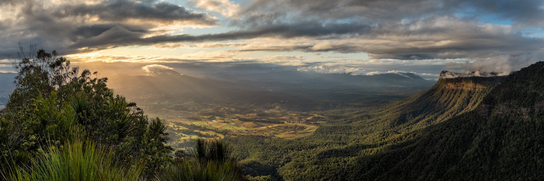 A Panorama Photography Print for Homes and Apartments of a sunrise over a hinterland with Fog and Clouds over the mountains.