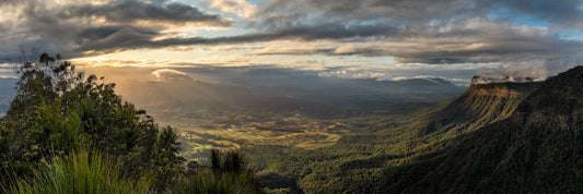 A Panorama Photography Print for Homes and Apartments of a sunrise over a hinterland with Fog and Clouds over the mountains.