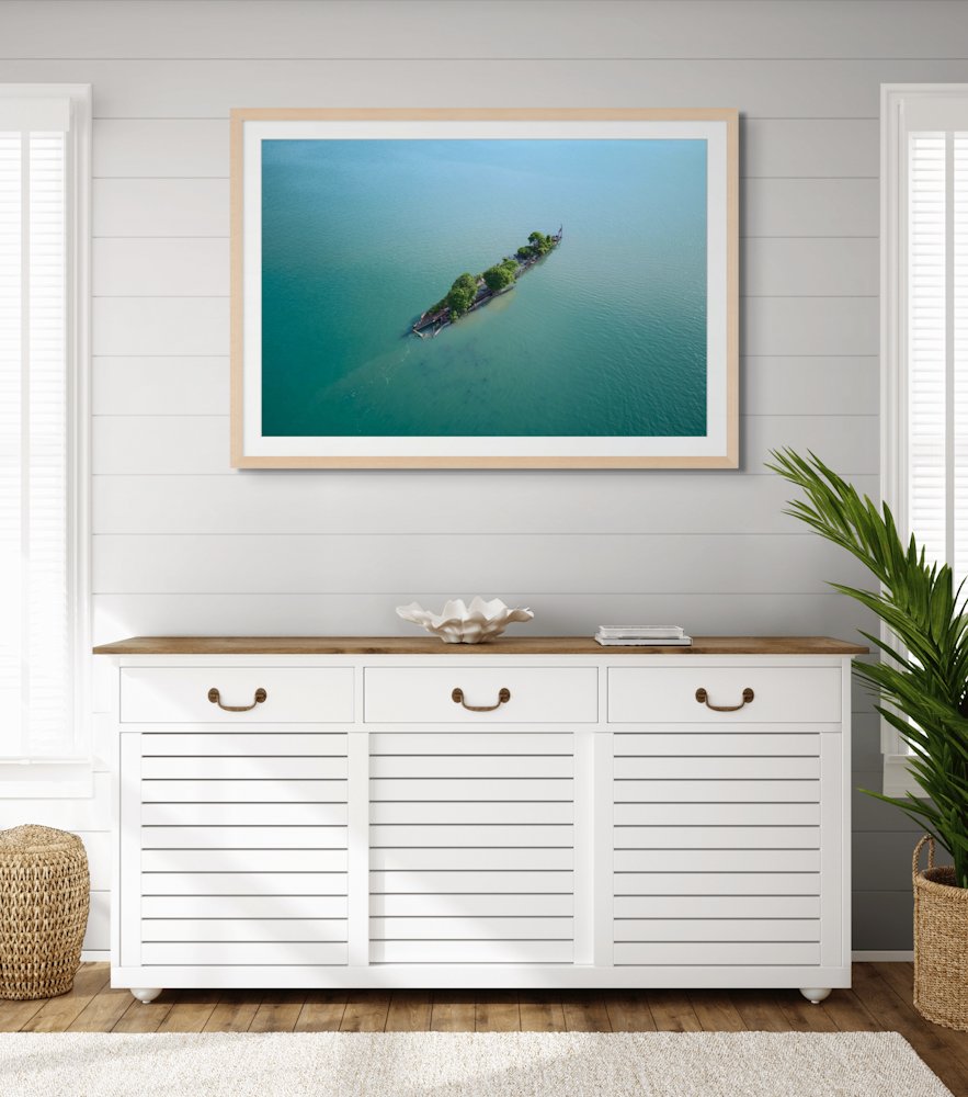 Australian Aerial photography wall art with an oak frame above a white buffet unit.