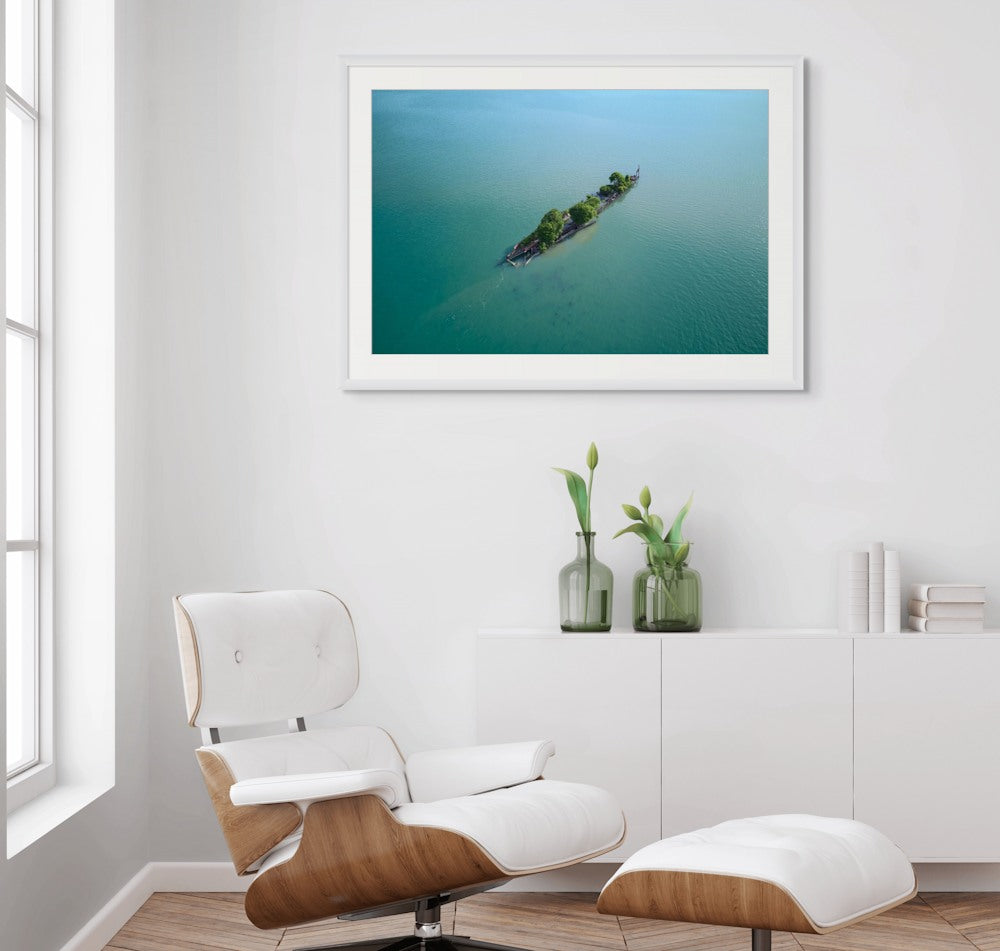 Australian Aerial photography wall art  above a modern chair and cabinet setup.